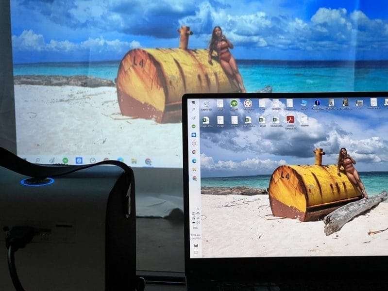 a laptop with a wide screen projector